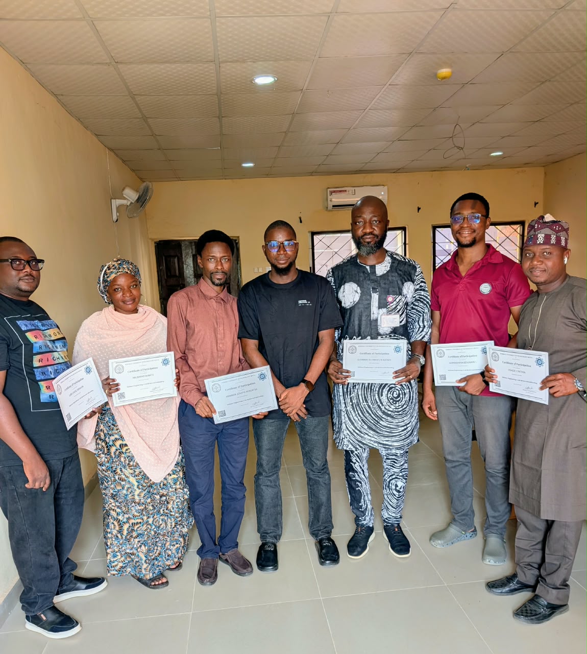 Staff holding their certificates of participation after the SWEMLab workshop