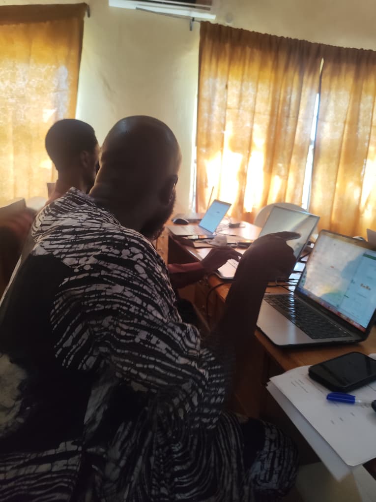 A staff member working through a SWEMLab activity on a laptop