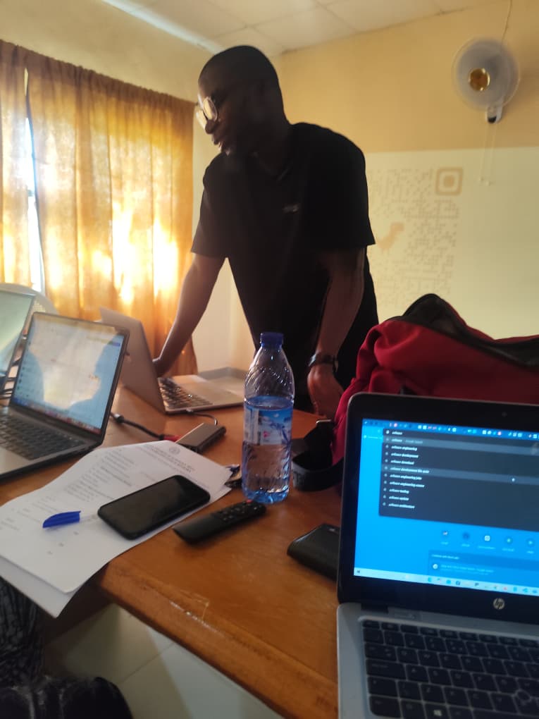 Rasheed walking a staff member through SWEMLab on a laptop