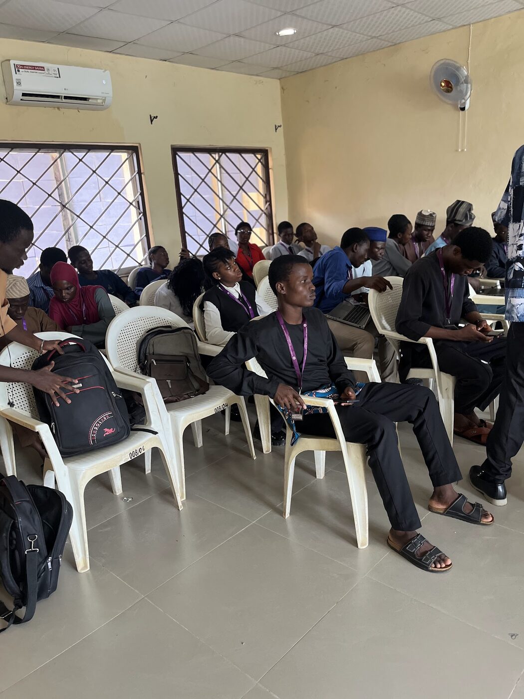 Students seated with their laptops, waiting to present their projects